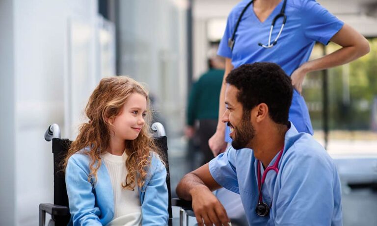 Medical professionals with girl in wheelchair