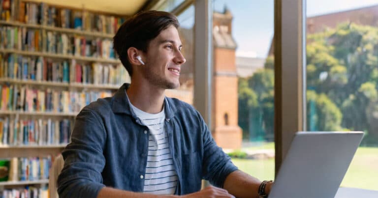 Male postgraduate student studying in library