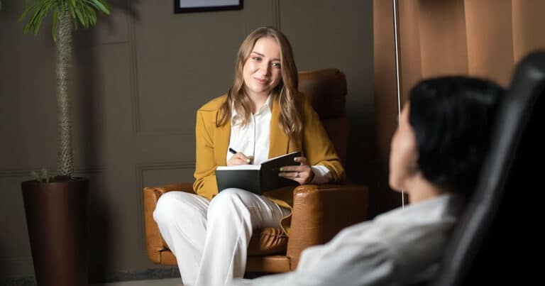 Psychologist with client taking notes