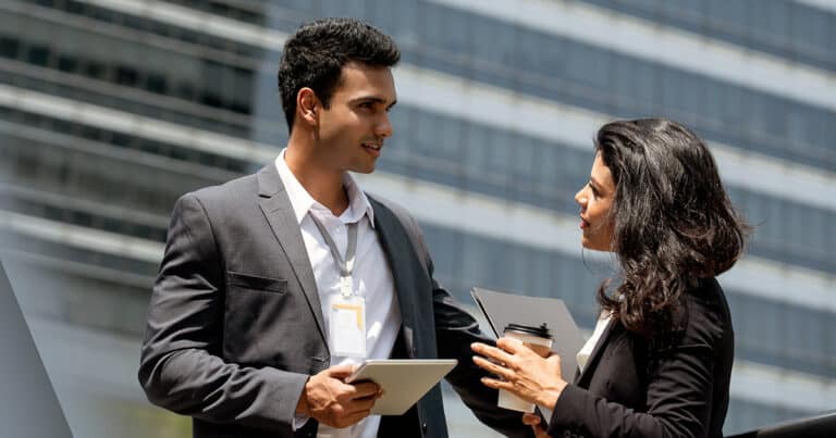 Young professionals in discussion outside city building